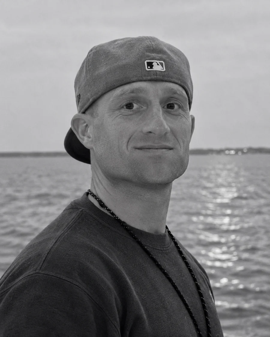 Chad Hoeffler wearing a cap beside the water