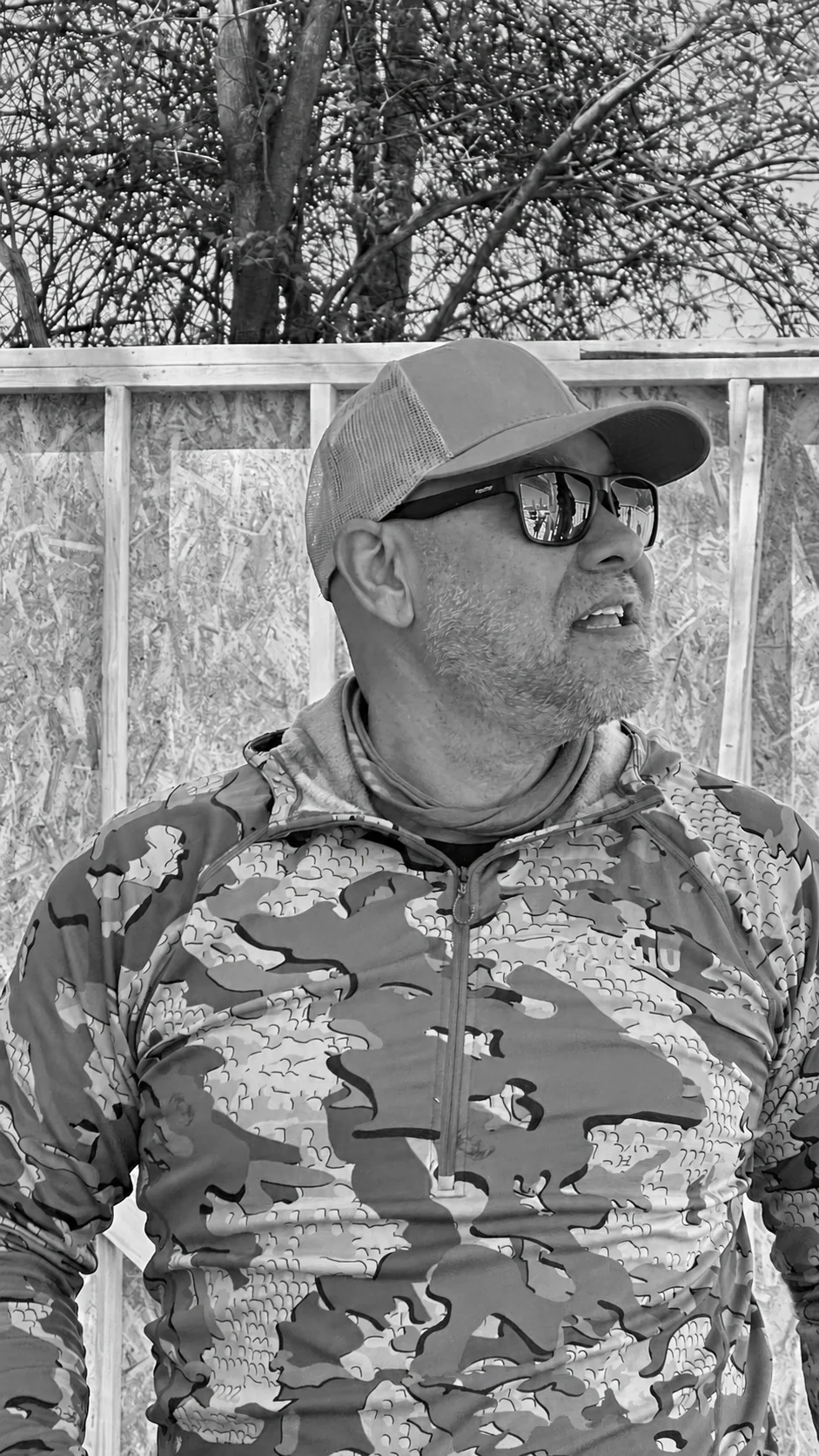 Doug, founder of The Grid Collective, outdoors beside timber framing